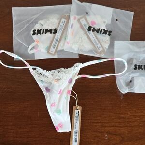 SKIMS Marble Candy Heart Print Lace String Thong - White with Pastel Hearts.